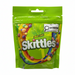 Green bag of Skittles candy with colorful candy pieces visible through the transparent section.